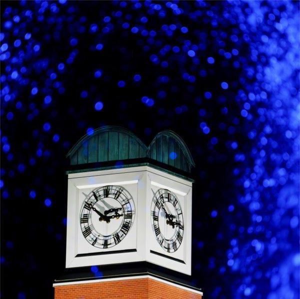 The Cook Carillon Tower is pictured through the blue water of the Zumberge Pond fountain.